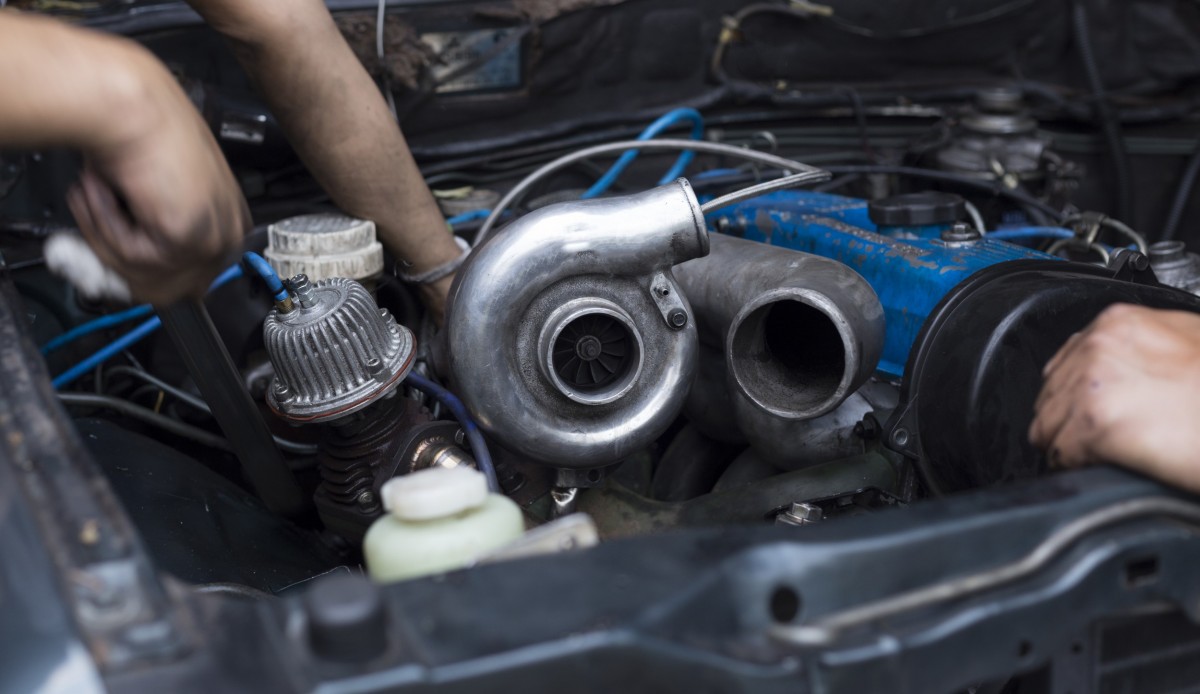 mechanic fixing turbocharger