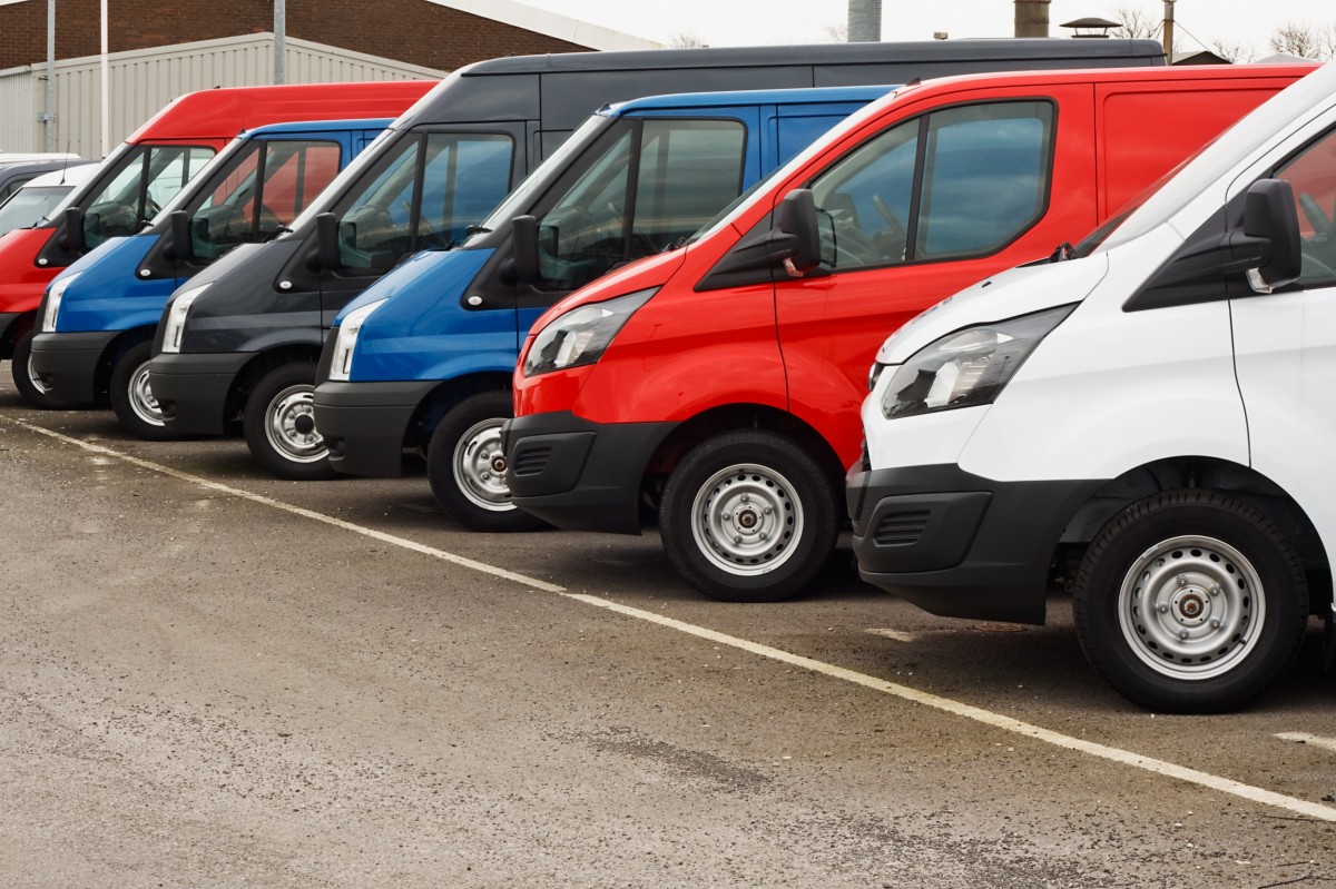 fleet of six vans that are red and blue 